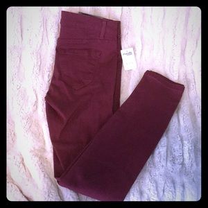 Maroon jeans.